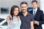 couple with keys and car salesman