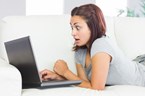 shocked woman looking at computer screen