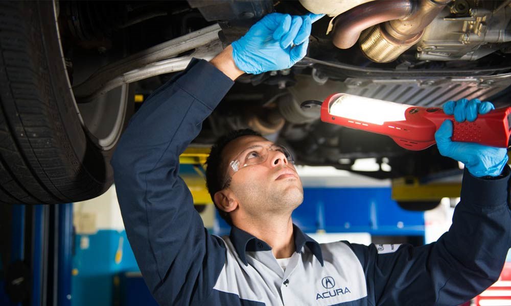 Acura Technician Inspecting Under Car