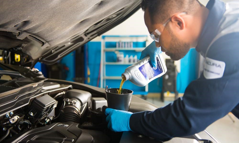 Acura Technician Changing Oil